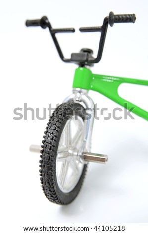 bike toy standing on white background (shallow DOF)