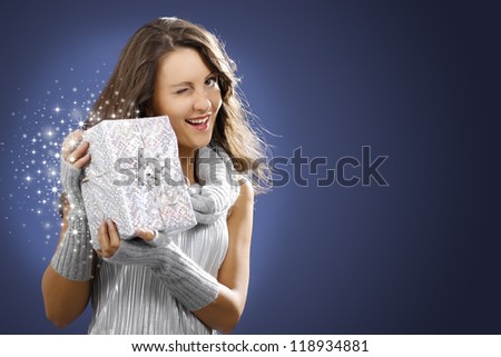 Beautiful smiling woman with angel wings holds a silver gift