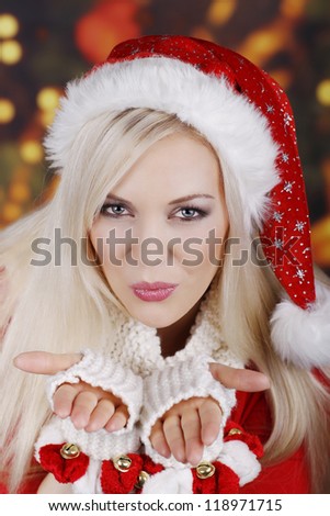 Smiling woman in santa costume with kissing lips
