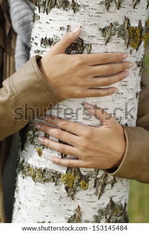 Arms around a birch tree