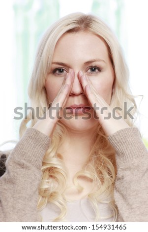 woman touches her nose
