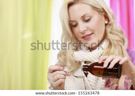 attractive woman takes medicine from a bottle