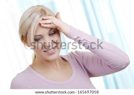Blonde woman with headache
