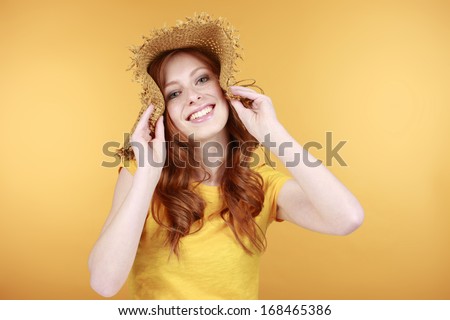 Attractive woman with straw hat and sensitive skin
