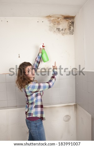 Woman points to a mould spot on the wall