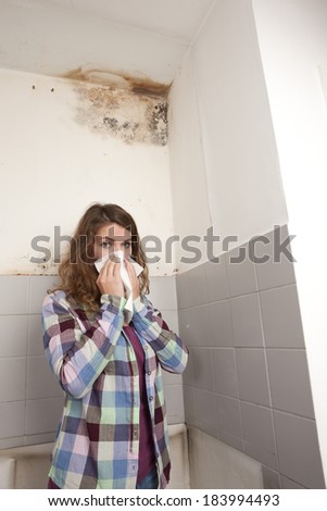 Woman points to a mold spot on the wall