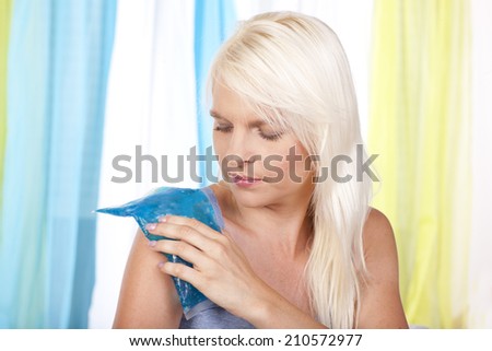 Woman with shoulder pain and cold pack
