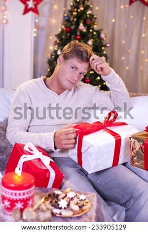 Sad single man with christmas gift