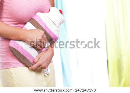Young woman with hot bottle and bladder infection