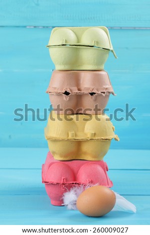 colorful pile of chicken egg carton on blue background
