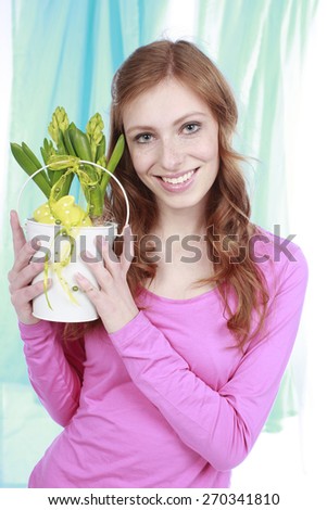 Woman with narcissus in a pot