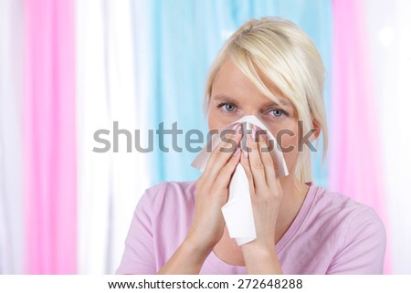 Woman blowing her nose with a handkerchief