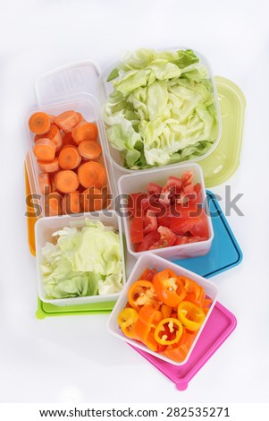 Different plastic boxes for storage with vegetables