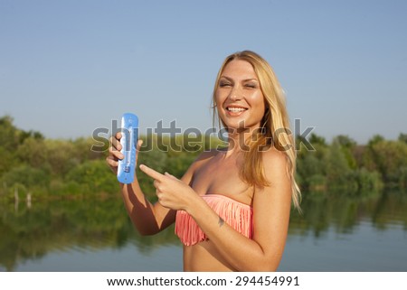 Young woman with thermometer in summer outdoor