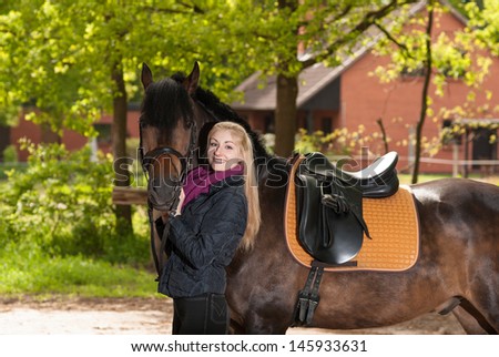 Fair-haired girl with her brown pony (New-Forest-Pony)