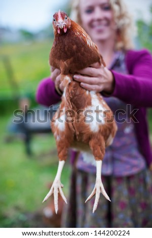 woman holding farm chicken
