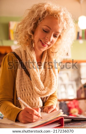 young woman writing on desk