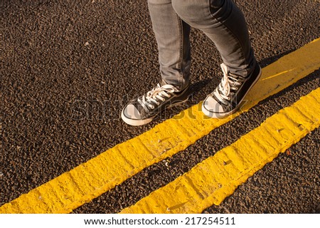 walking on yellow street lines