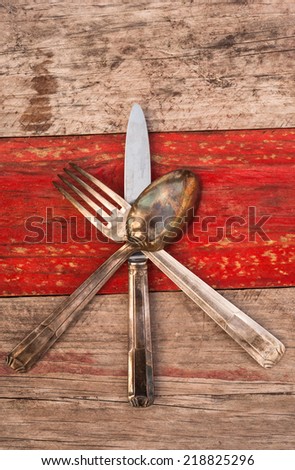 Cutlery kitchenware on rustic grungy wood texture background