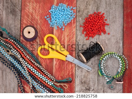 bead making accessories on grunge wood background