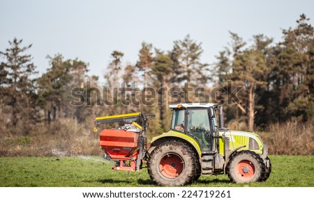 Tractor spraying rural farm field