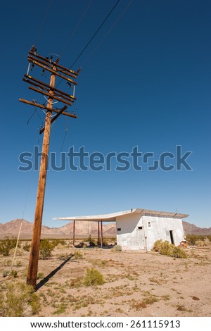 old vintage power lines and abandoned building in the mojave desert