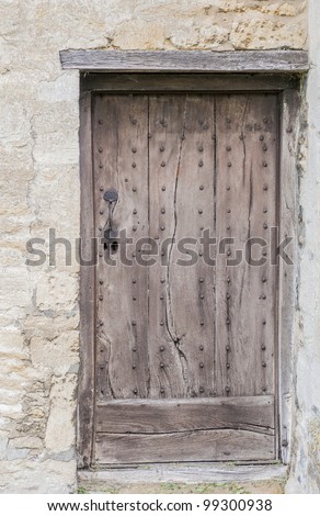 Old wooden door with a wooden lintel set in stone