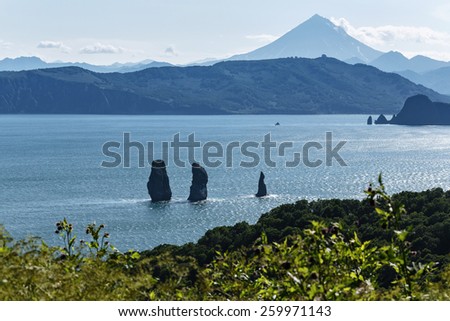 Three Brothers Rocks in Avacha Bay and Viluchinsky volcano. Russia, Far East, Kamchatka Peninsula.