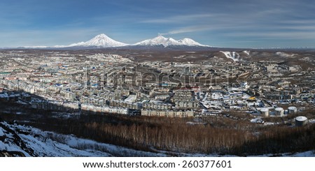 Panoramic view of the city Petropavlovsk-Kamchatsky and volcanoes: Koryaksky Volcano, Avacha Volcano, Kozelsky Volcano. Far East, Russia, Kamchatka Peninsula.