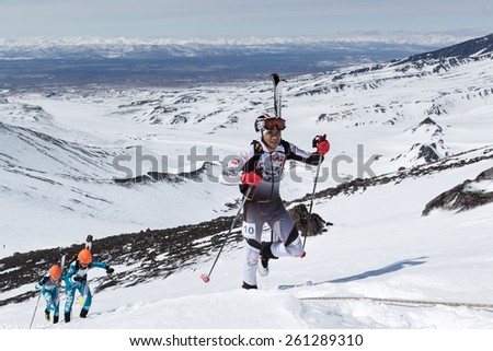 AVACHA VOLCANO, KAMCHATKA, RUSSIA - APRIL 26, 2014: Aleksei Zagorski rises (with skis strapped to backpack) on volcano. Individual race ski mountaineering Asian, ISMF, Russian, Kamchatka Championship.