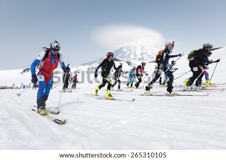 KORYAK, AVACHA VOLCANOES, KAMCHATKA, RUSSIA - APRIL 27, 2014: Mass start race, ski mountaineers climb on skis on mountain. Team Race ski mountaineering Asian, ISMF, Russian, Kamchatka Championship.