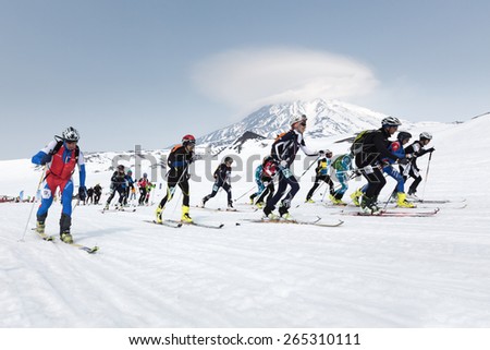 AVACHA, KORYAK VOLCANOES, KAMCHATKA, RUSSIA - APRIL 27, 2014: Mass start race, ski mountaineers climb on skis on mountain. Team Race ski mountaineering Asian, ISMF, Russian, Kamchatka Championship.