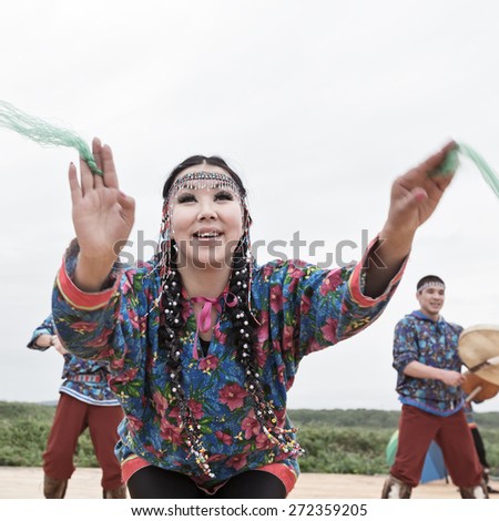 KAMCHATKA, RUSSIA - AUGUST 9, 2014: Emotional woman dance. Public concert Koryak Folk Dance Ensemble Angt on the Khalaktyrsky Beach around City Petropavlovsk-Kamchatsky.