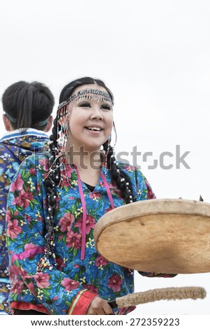 KAMCHATKA, RUSSIA - AUGUST 9, 2014: Expression woman dancing with a tambourine. Public concert Koryaksky folk dance ensemble Angt on the Khalaktyrsky Beach around City Petropavlovsk-Kamchatsky.