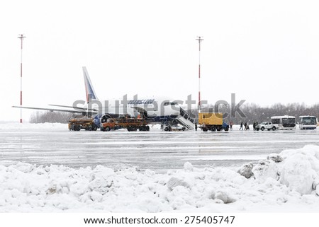 KAMCHATKA, RUSSIA - MARCH 19, 2015: Service and technical support airfield maintenance airplane Boeing-767 Transaero Airlines at airport of Petropavlovsk (Yelizovo) during a snowfall, poor visibility.