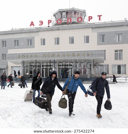 PETROPAVLOVSK-KAMCHATSKY, KAMCHATKA, RUSSIA - MARCH 19, 2015: Winter view of the airport terminal Petropavlovsk-Kamchatsky (Elizovo airport) and the station square with the people with baggage.