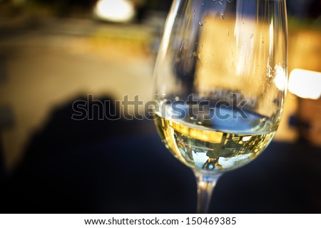 A Glass Of White Wine In An Isolated Background.