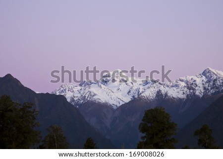 The highest mountain in New Zealand in the dusk, on a purple sky. Mount Cook, New Zealand.