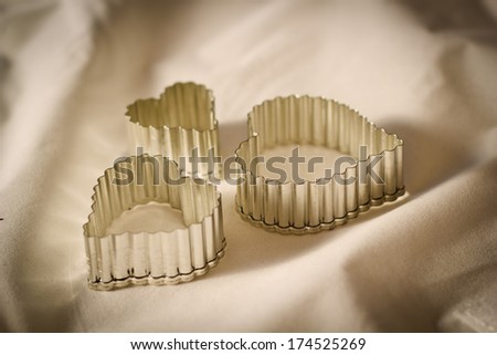 Metal rough molds heart shaped on a white vintage background isolated. Love in Valentine's Day.