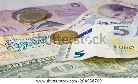 Different banknotes and coins from Europe, USA, Seychelles, Australia and Turkey.