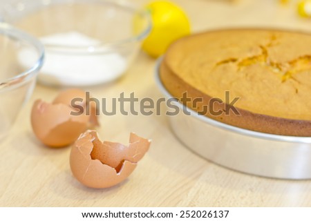 Egg shells on a kitchen with some other ingredients to bake a cake.
