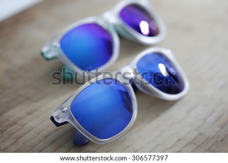 Fashion colorful sunglasses isolated on a wooden background