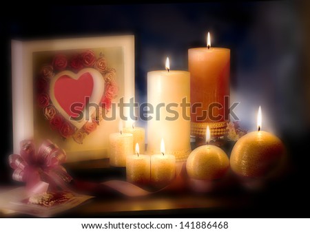 Pink and White Candles  on Dark Background . Candlelight and Cookies Lighting.at side is white photo frame with heart in center.
