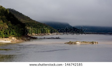 River in Laos Landscape. River and Mountain in Long shot view. fog over Sky.background is mountain.