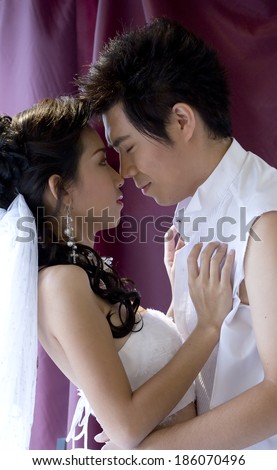 Just Married in love action. Sweetheart embrace together.Man close eyes in dream.Girl open eyes to honey face.