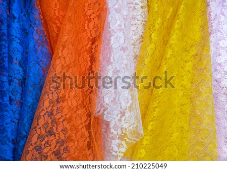 Lace Fabric display in fabric shops,blue,orange,pink and yellow color.