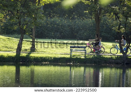 BANGKOK,THAILAND-OCTOBER 10, 2014: People ride bicycles in Jatujak Train Public Park,famous and celebrated public park in Bangkok.