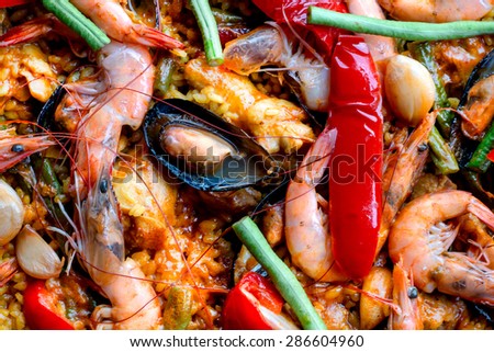 Paella Seafood which simmer with rice,shrimp,green mussels,squid,olive oil,tomato,saffron,pepper,tomato and another vegetables.