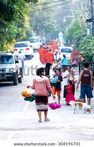 LUANG PRABANG,LAOS - 12 APRIL 2015 :  Laos women back home after offer food to monk.Every day laos people plentifully offer food to monk that is charm and attract for tourist.