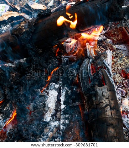 Close up bonfire from wood,black charcoal,ashes and flame by top view shot.